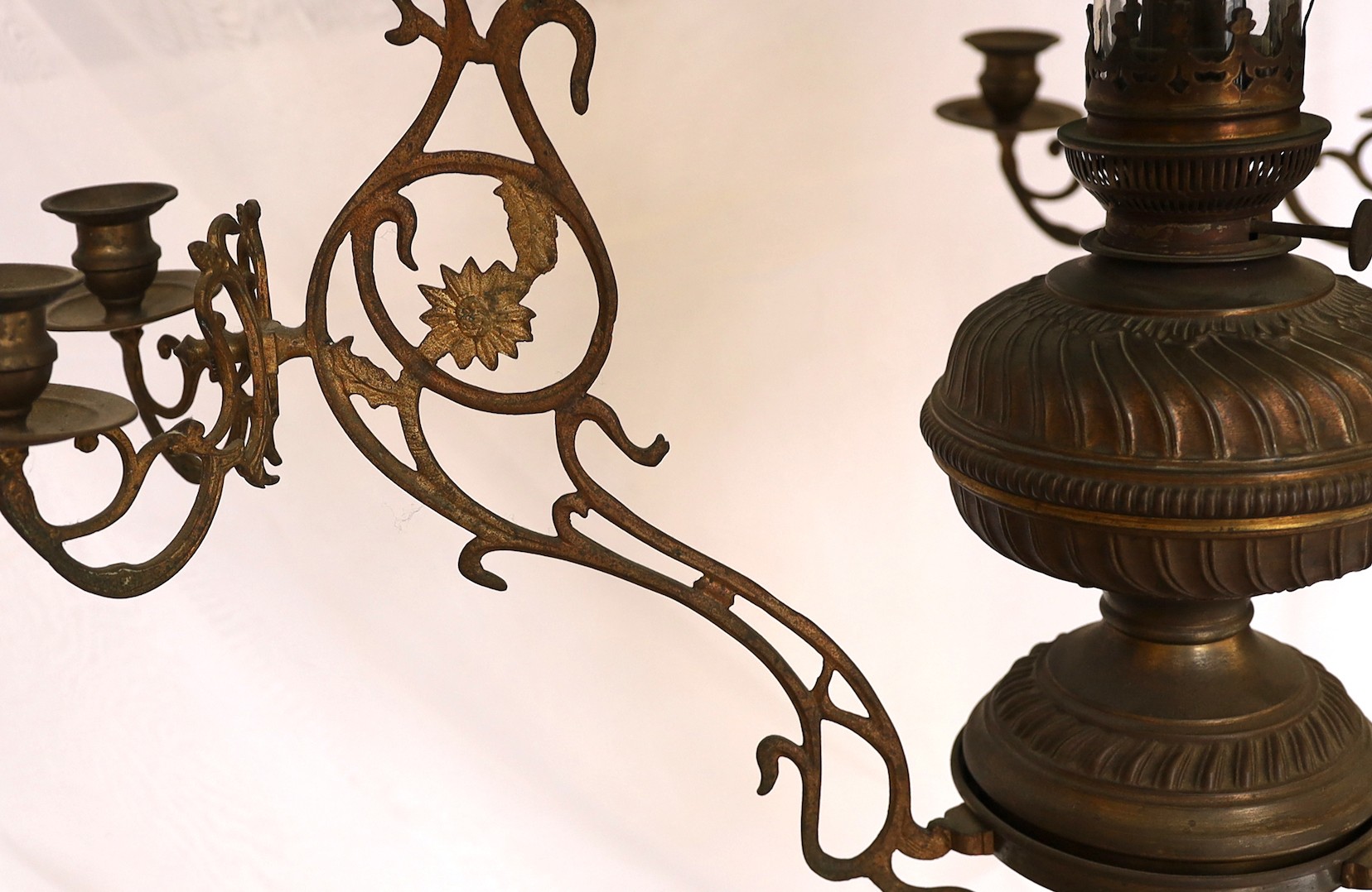 A Victorian brass counterbalanced hanging oil lamp with opaque blue glass shades and six candle sconces to the arms, height 136cm